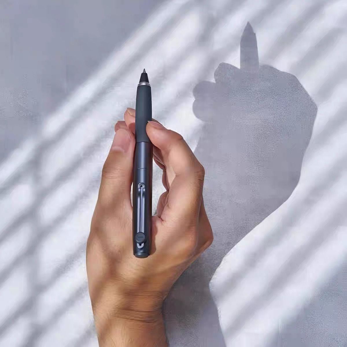 Uni-ball Zento Signature Metallic Black rollerball pen held in hand lifestyle shot