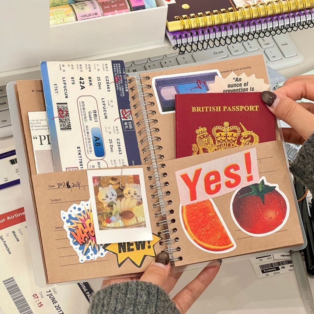 A5 kraft paper travel journal lifestyle flat lay with boarding passes stickers and pens on desk