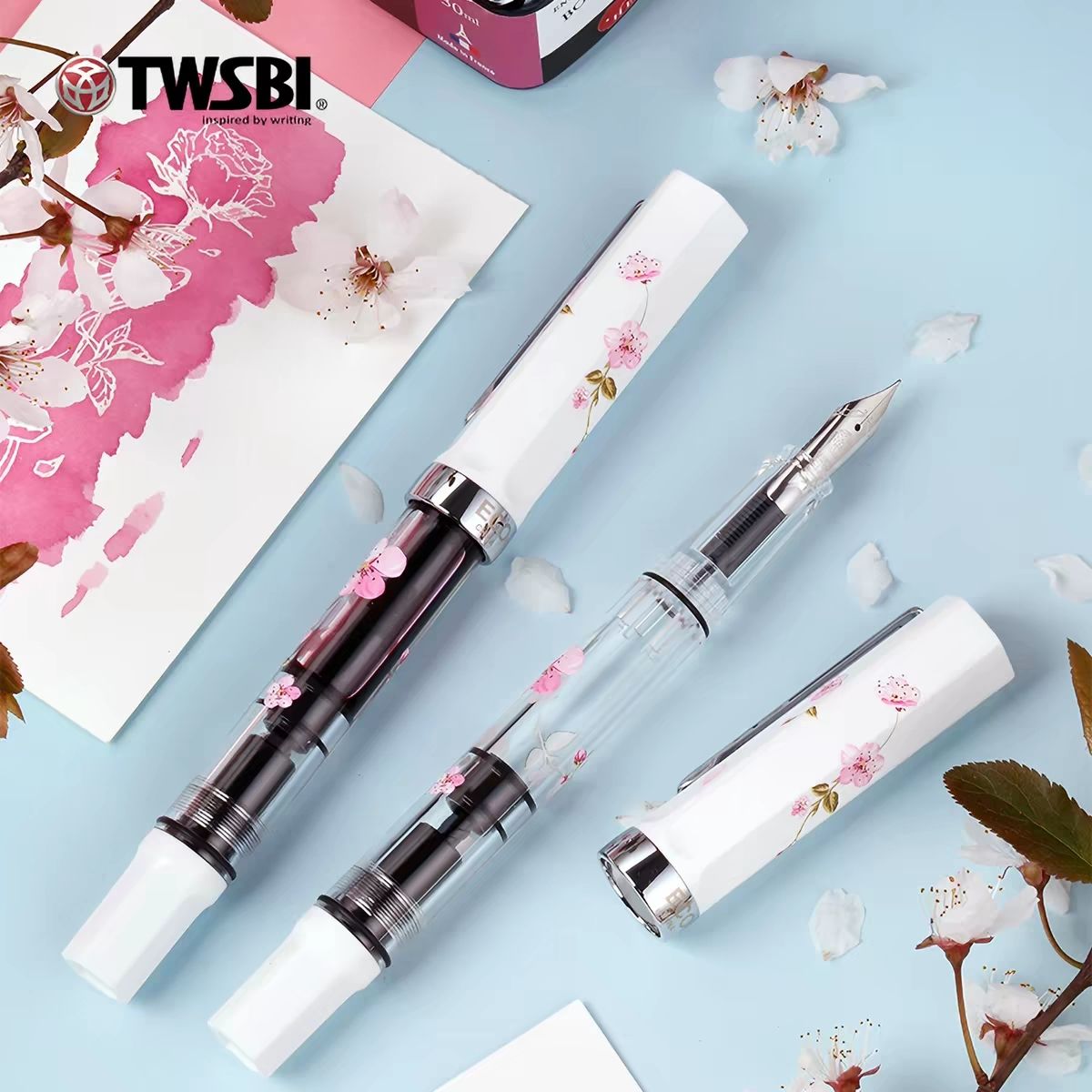 TWSBI ECO Sakura limited edition fountain pens with cherry blossom artwork on white caps and clear barrels